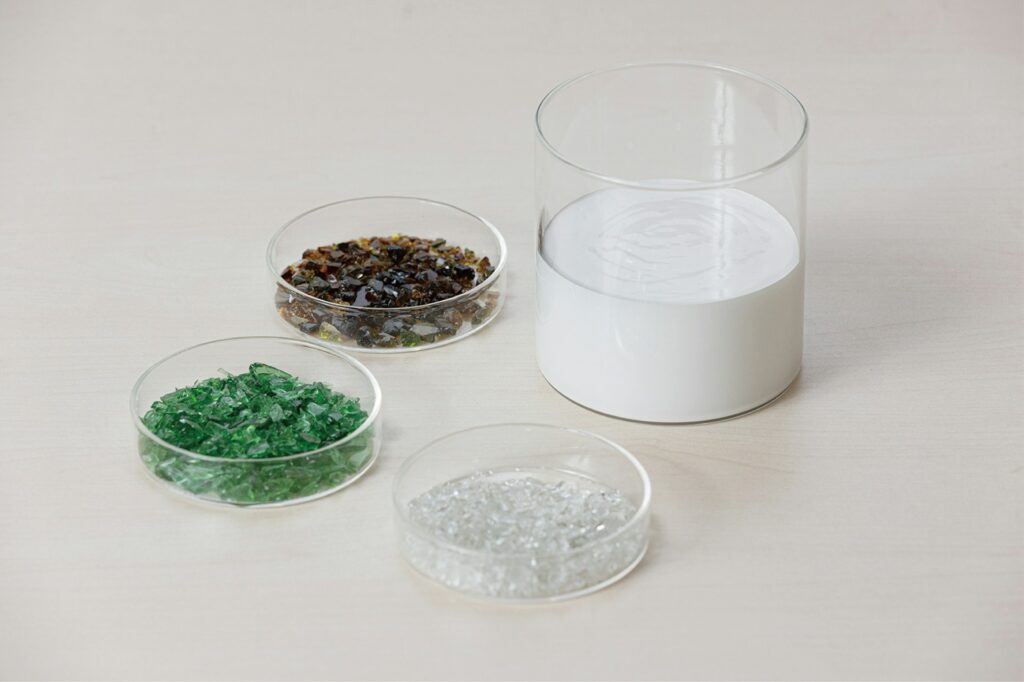 On a clean tabletop, several plastic containers hold different substances