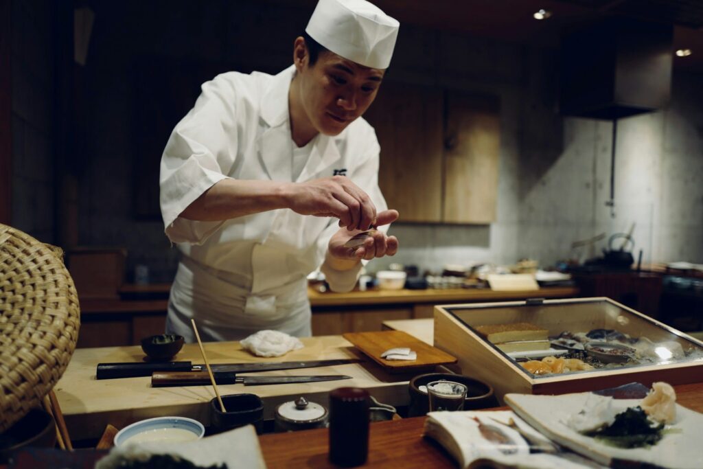 The chef is carefully preparing sushi