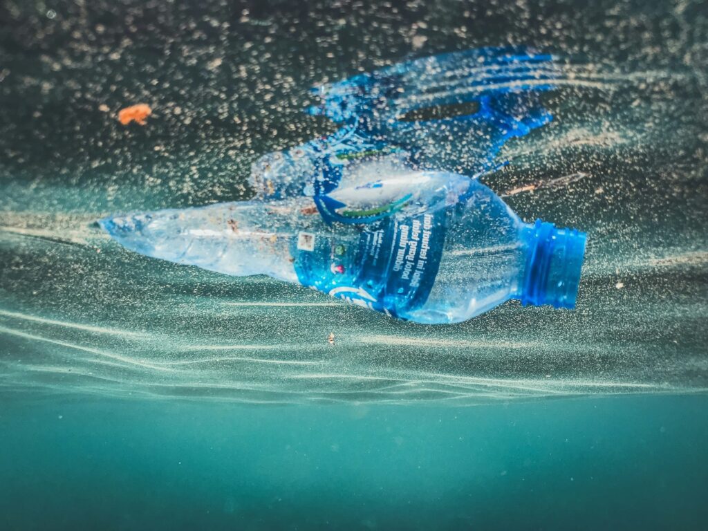 Discarded PET plastic bottle floating in water