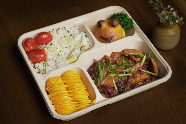 Disposable compartment food container filled with delicious meals