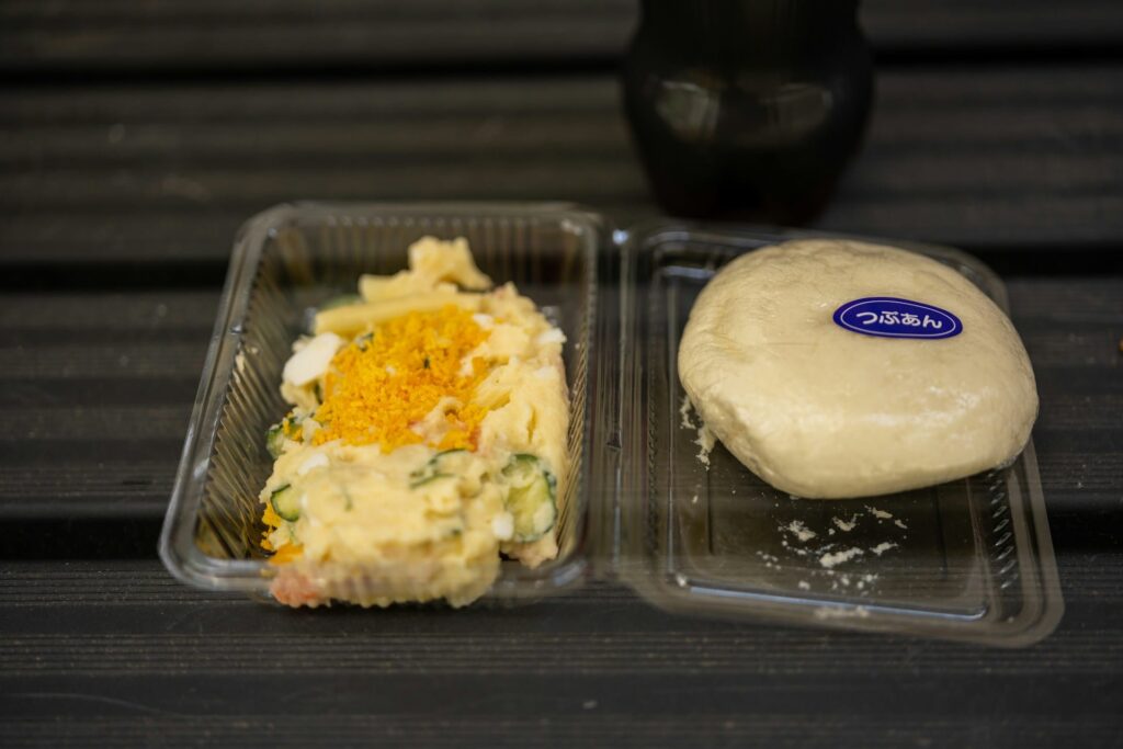 Plastic clamshell container filled with potato salad