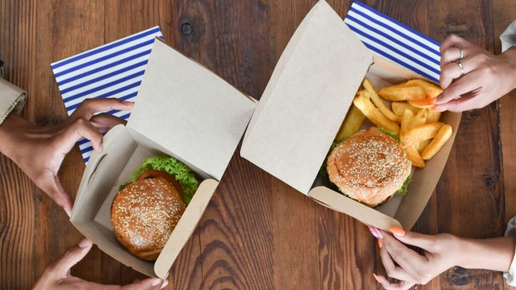 kraft paper burger box containing a freshly made hamburger